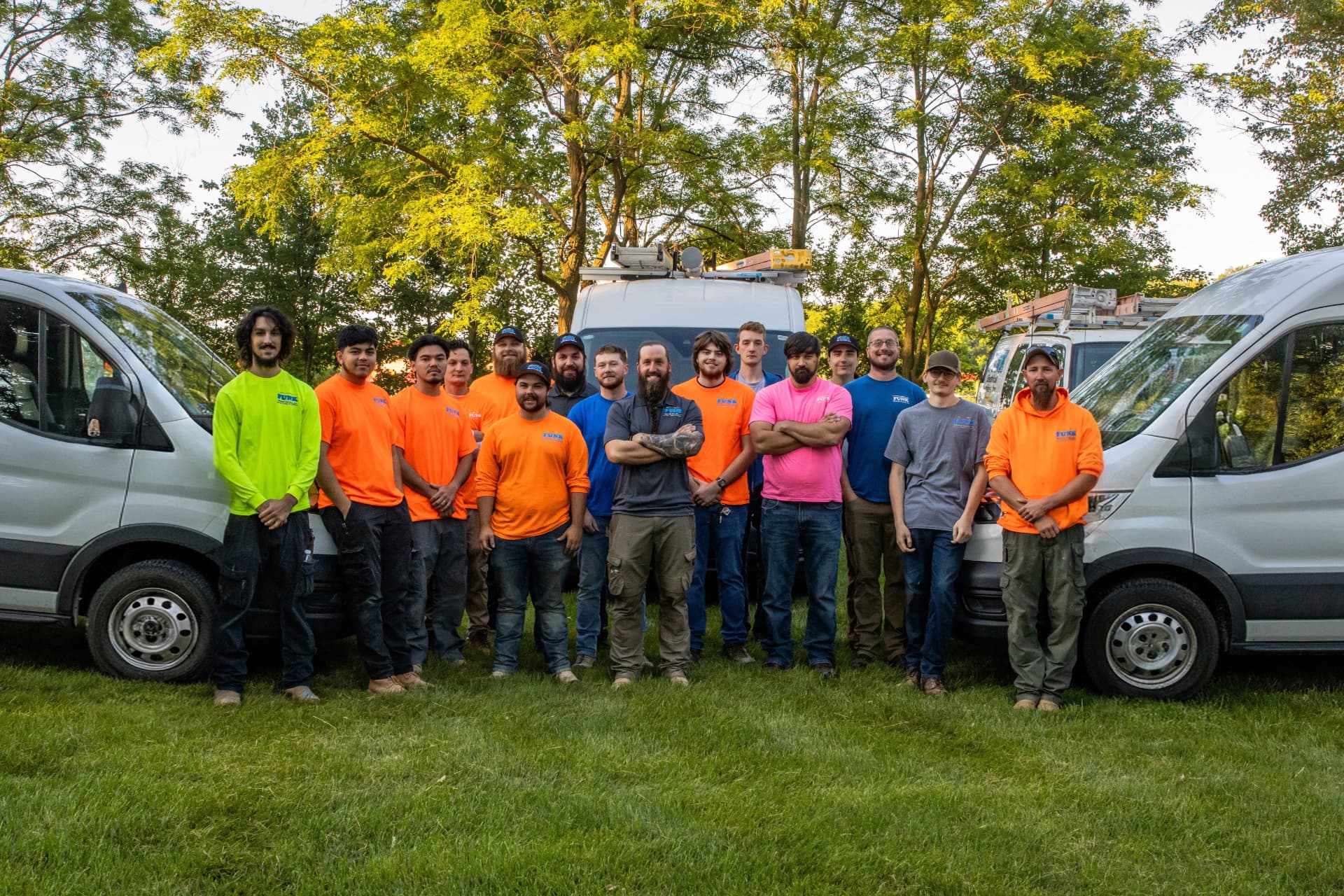The Funk Electrical construction crew lined up in front of the company vans